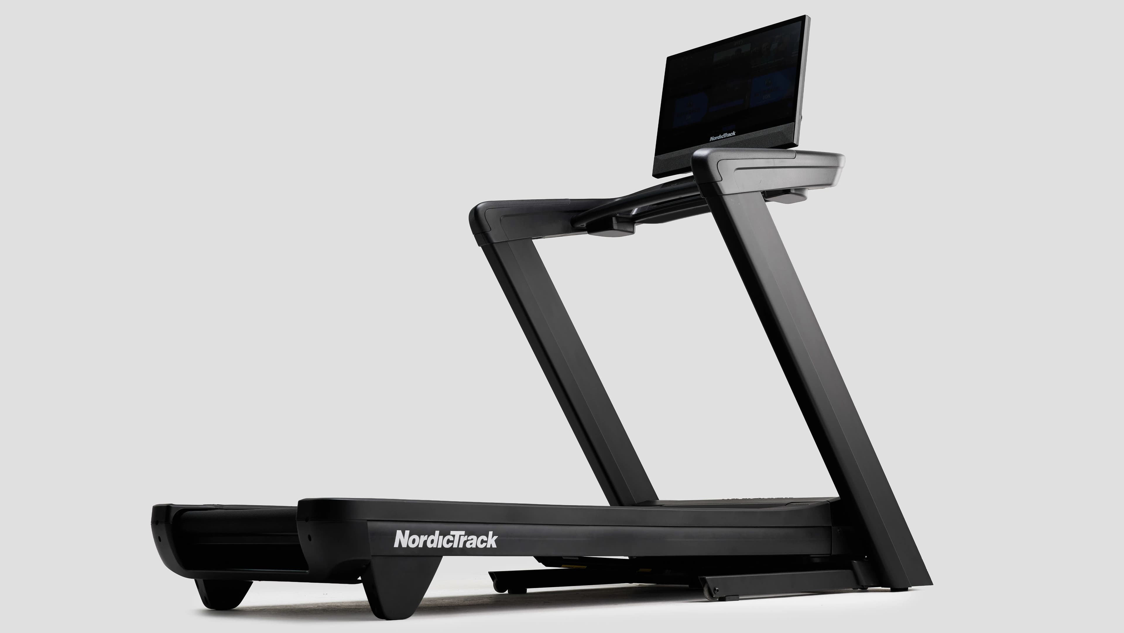 NordicTrack Commercial 2450 Treadmill with a reinforced frame and touchscreen, wrapped with a gold bow.