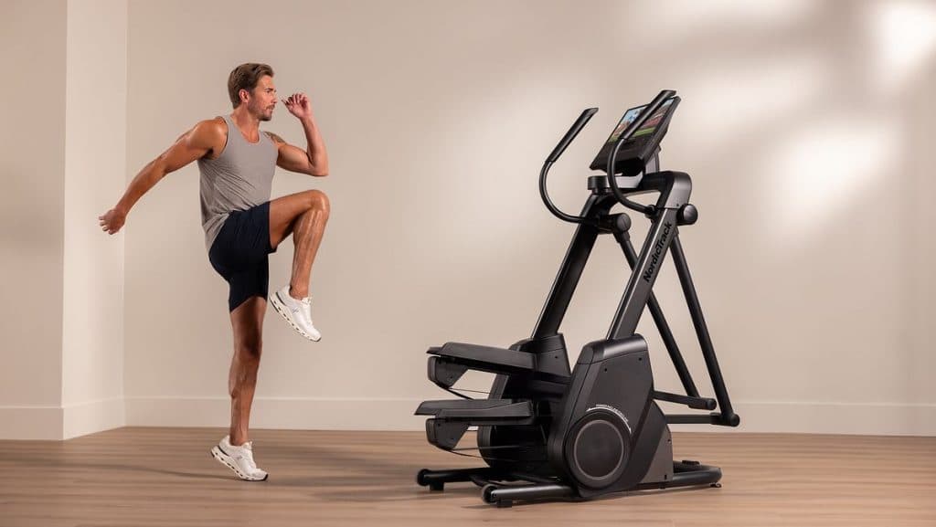 Individual performing high-intensity cardio on a NordicTrack stair climber, highlighting immersive, connected workouts.