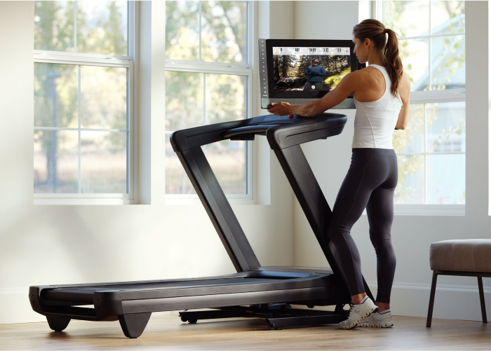 Woman Using an iFIT Workout at Home on Her NordicTrack Treadmill