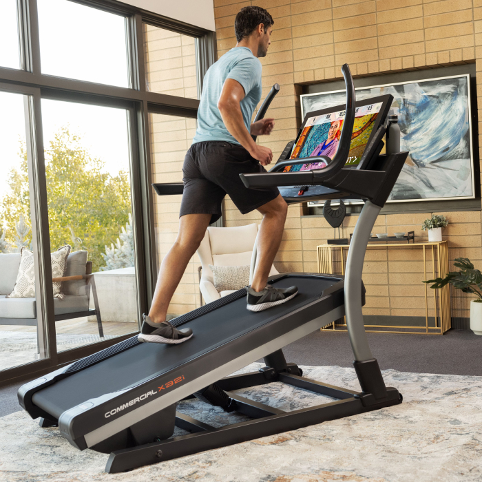 Man Using a NordicTrack Incline Treadmill as He Experiences the Health Benefits of Incline Treadmills