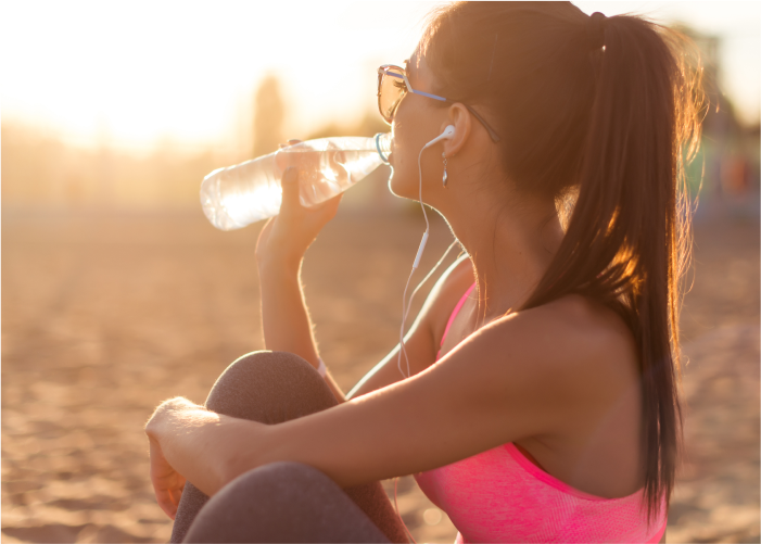 Woman Drinking Water to Stay Hydrated and Fit During the Summer Months