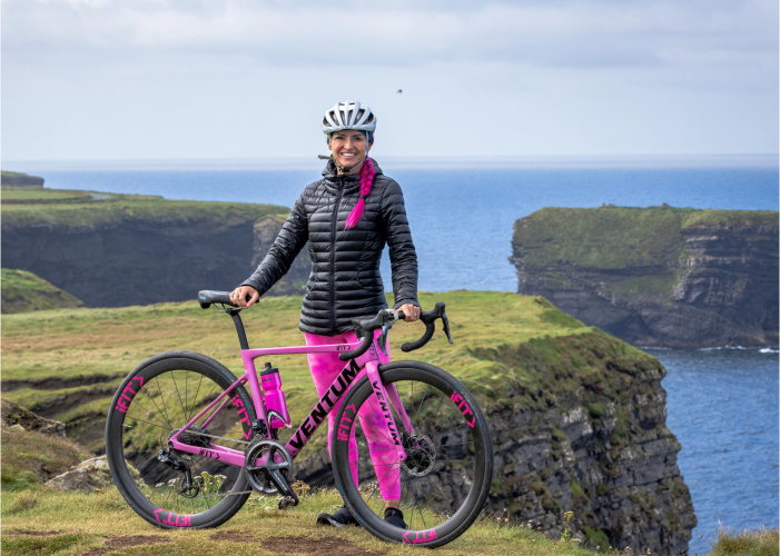 iFIT Trainer Ashley Paulson Poses with Her Bike on the Ireland Coast-to-Coast Series across Emerald Isle
