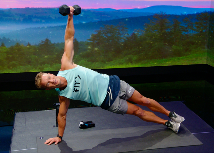 iFIT Trainer John Peel is Practicing a Side Plank and Leading a Workout That Includes a Built-In Progressive Overload