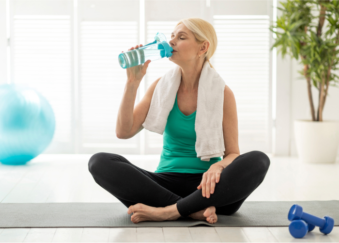 Older Woman Sipping Water After a Solid Workout
