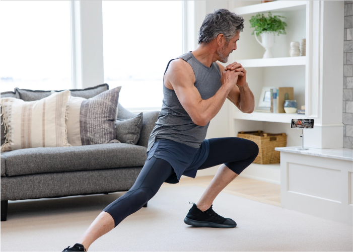 Older Man Performing a Side Lunge as He Exercises in His 50s and Beyond
