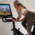 Woman Riding Her NordicTrack Exercise Bike for the Article on How Biking Can Make You Run Faster