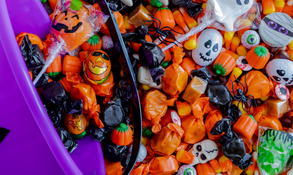 Bowl of Halloween Candy Dumped Out for the Article How to Enjoy Halloween Candy and Still Reach Your Health Goals