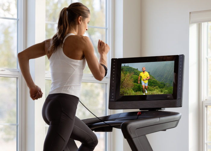 Woman Running with iFIT and SmartAdjust™ on NordicTrack Treadmill