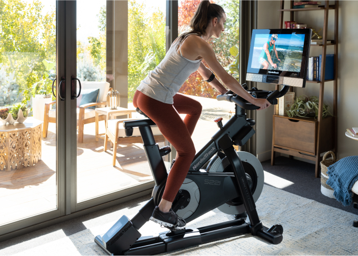 Woman Riding a Studio-Style NordicTrack Stationary Exercise Bike